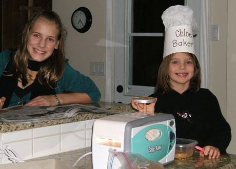 Lauren and Chloe enjoy baking cookies in their new Easy Bake oven.