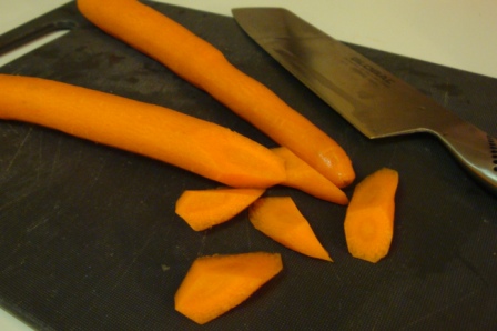 Oblique cut: cut carrots at a 45 degree bias, quarter turn it towards you so the cut side faces up, cut again at 45 degree right through the middle of the cut face. Quarter turn it again and repeat the process.