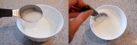 Milk being mixed into two tablespoons of yogourt