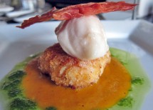 Olive oil poached halibut on a chorizo croquette with saffron emulsion and chive oil topped with a crispy prosciutto chip.